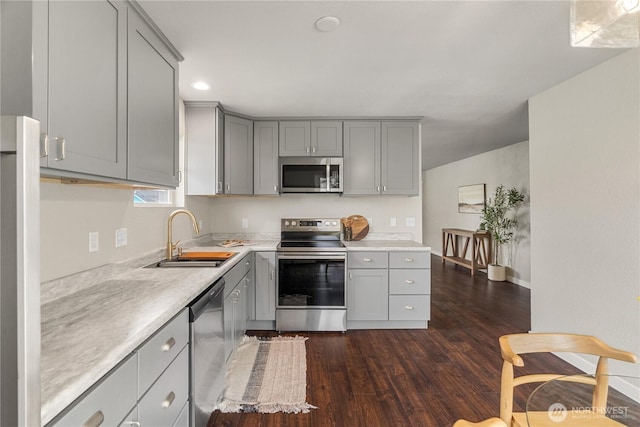 1608 W Market St, Aberdeen, WA 98520 - kitchen featuring stainless steel appliances, gray cabinets, light countertops, and dark wood-style flooring