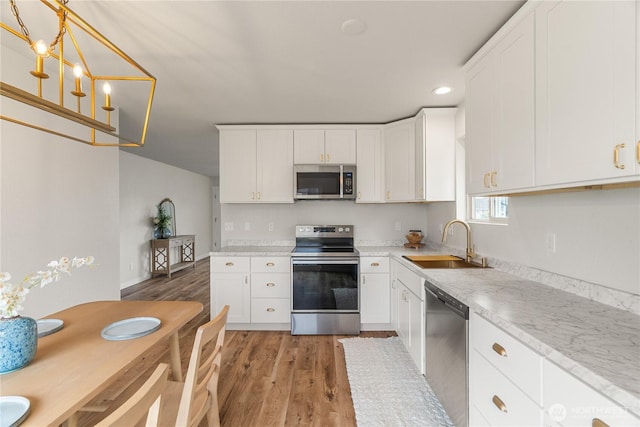 1604 W Market St, Aberdeen, WA 98520 - kitchen featuring stainless steel appliances, light wood finished floors, light countertops, white cabinetry, and recessed lighting