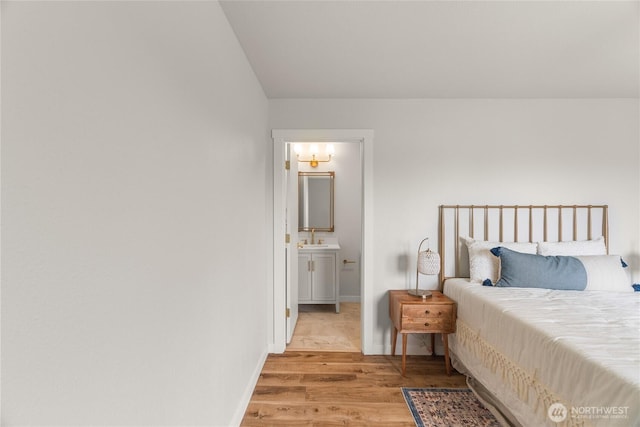 1604 W Market St, Aberdeen, WA 98520 - bedroom with light wood finished floors, ensuite bathroom, and lofted ceiling