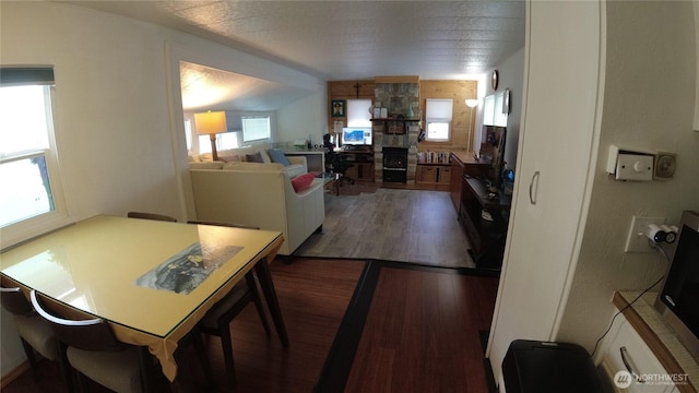1200 Lincoln St Unit 148, Bellingham, WA 98229 - dining space featuring dark wood-type flooring and a stone fireplace