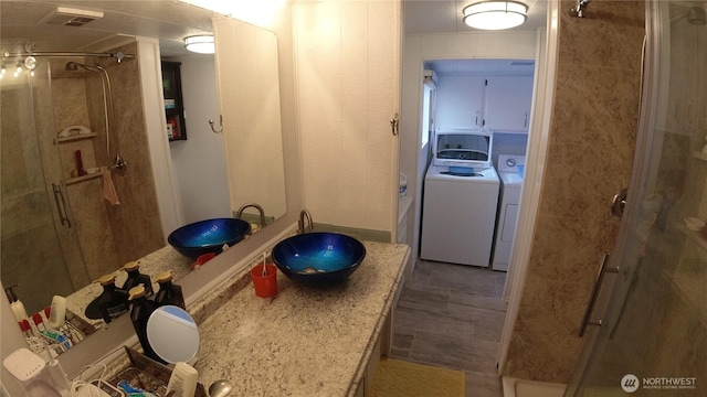 1200 Lincoln St Unit 148, Bellingham, WA 98229 - bathroom with washing machine and clothes dryer, a stall shower, and vanity