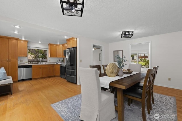 31609 41st Ave SW, Federal Way, WA 98023 - dining room featuring light wood-type flooring, a textured ceiling, and recessed lighting