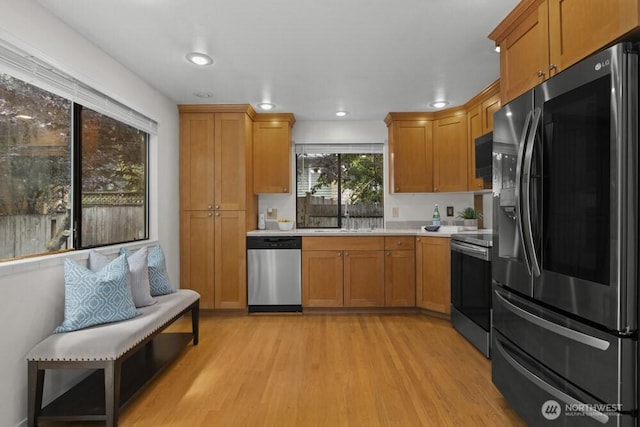 31609 41st Ave SW, Federal Way, WA 98023 - kitchen featuring stainless steel appliances, light wood-style flooring, light countertops, brown cabinets, and recessed lighting