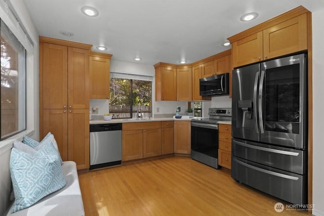 31609 41st Ave SW, Federal Way, WA 98023 - kitchen with stainless steel appliances, light countertops, light wood-type flooring, recessed lighting, and brown cabinets