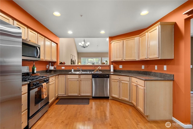 6547 Lindsay Ave SE Unit 18C, Auburn, WA 98092 - kitchen featuring stainless steel appliances, light wood-style floors, a chandelier, dark countertops, and recessed lighting