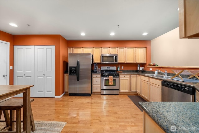 6547 Lindsay Ave SE Unit 18C, Auburn, WA 98092 - kitchen with appliances with stainless steel finishes, light brown cabinetry, light wood finished floors, dark countertops, and recessed lighting
