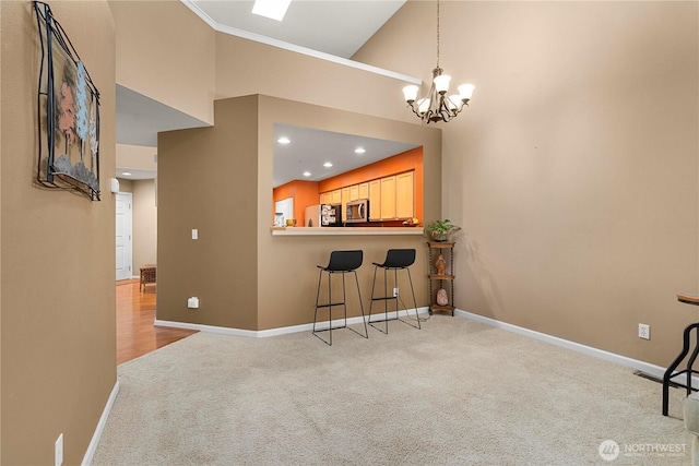 6547 Lindsay Ave SE Unit 18C, Auburn, WA 98092 - kitchen with carpet flooring, freestanding refrigerator, stainless steel microwave, a high ceiling, and a chandelier
