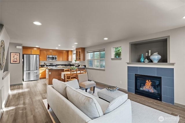 923 N 85th St Unit A, Seattle, WA 98103 - living area featuring light wood finished floors, recessed lighting, and a tiled fireplace