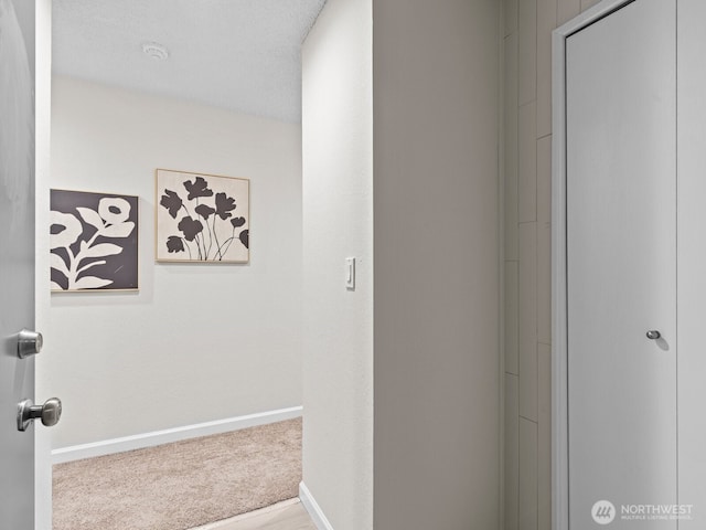 4920 200th St SW Unit A201, Lynnwood, WA 98036 - hallway featuring baseboards and carpet flooring