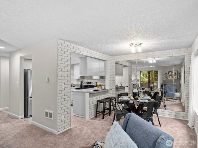 4920 200th St SW Unit A201, Lynnwood, WA 98036 - dining area with light colored carpet and a textured ceiling