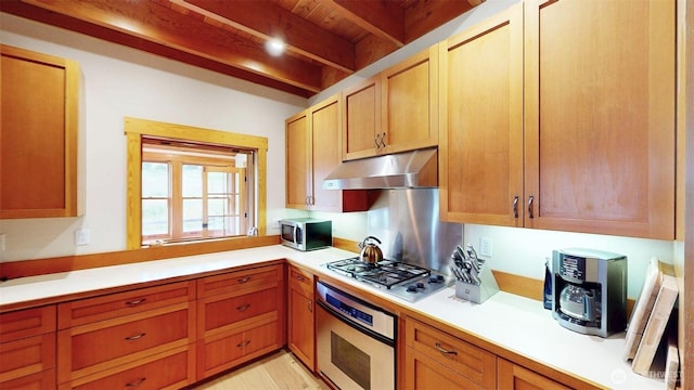 156 Poechmann Rd, Okanogan, WA 98840 - kitchen featuring stainless steel appliances, under cabinet range hood, beam ceiling, and light countertops