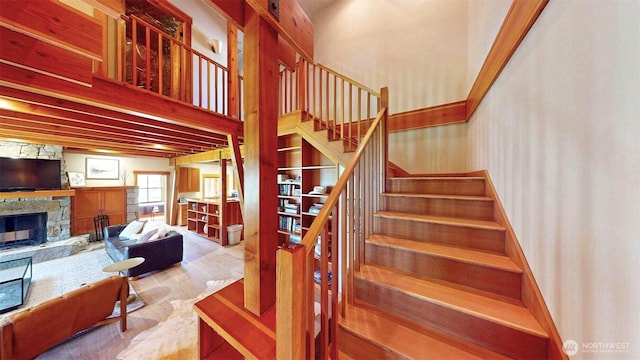 156 Poechmann Rd, Okanogan, WA 98840 - stairway featuring a stone fireplace, wood finished floors, and wallpapered walls