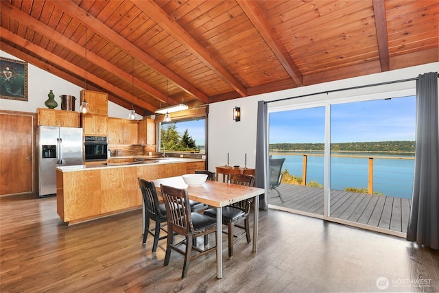 10806 W Morris Blvd, Steilacoom, WA 98388 - dining space featuring a water view, a wood ceiling with exposed beams, wood finished floors, and high vaulted ceiling