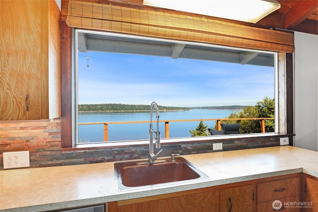 10806 W Morris Blvd, Steilacoom, WA 98388 - kitchen featuring healthy amount of natural light, a water view, brown cabinets, and light countertops