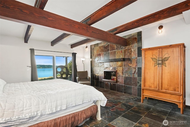 10806 W Morris Blvd, Steilacoom, WA 98388 - bedroom with beam ceiling, a water view, a tile fireplace, and dark stone finish flooring