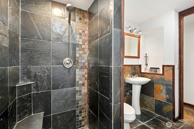 10806 W Morris Blvd, Steilacoom, WA 98388 - bathroom featuring tile walls, a tile shower, marble finish flooring, and a wainscoted wall