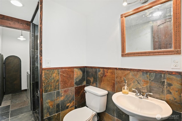 10806 W Morris Blvd, Steilacoom, WA 98388 - bathroom with tile walls, a wainscoted wall, and stone finish flooring