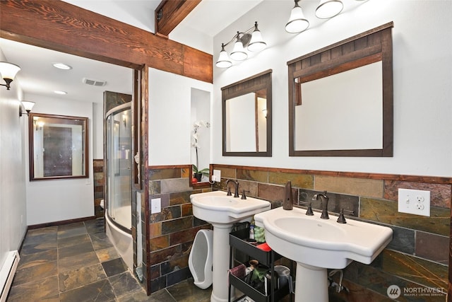 10806 W Morris Blvd, Steilacoom, WA 98388 - bathroom featuring stone tile floors, a shower stall, a baseboard radiator, tile walls, and recessed lighting