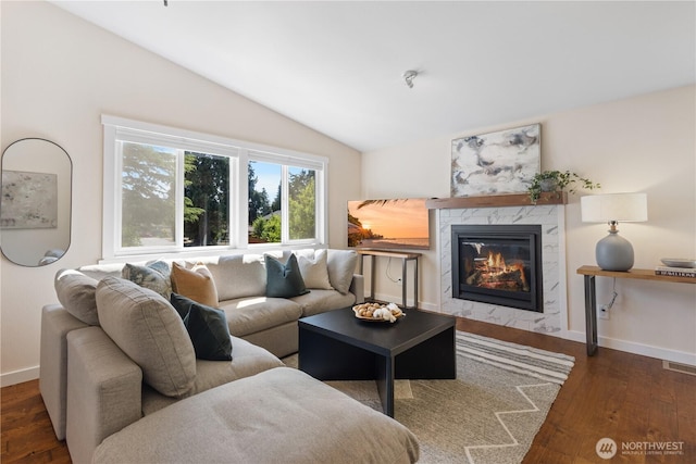 12712 NE 157th St, Woodinville, WA 98072 - living area featuring vaulted ceiling, wood finished floors, and a high end fireplace