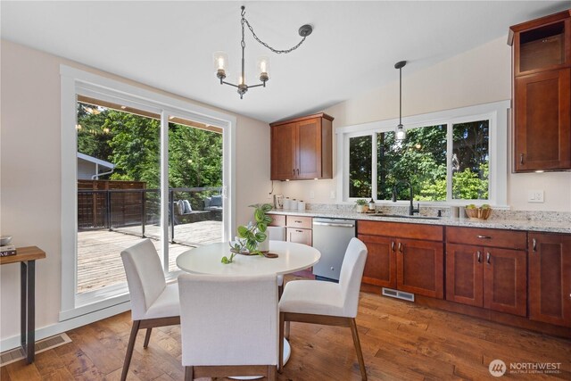 12712 NE 157th St, Woodinville, WA 98072 - dining space with healthy amount of natural light, wood finished floors, and a chandelier