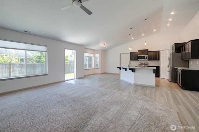 232 Jett Ct, Montesano, WA 98563 - unfurnished living room with a ceiling fan, lofted ceiling, light wood finished floors, and recessed lighting