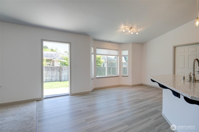 232 Jett Ct, Montesano, WA 98563 - kitchen featuring light wood finished floors, a kitchen bar, and light stone counters