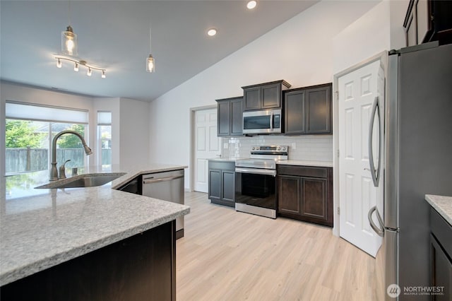 232 Jett Ct, Montesano, WA 98563 - kitchen featuring appliances with stainless steel finishes, light wood-style floors, recessed lighting, decorative backsplash, and vaulted ceiling
