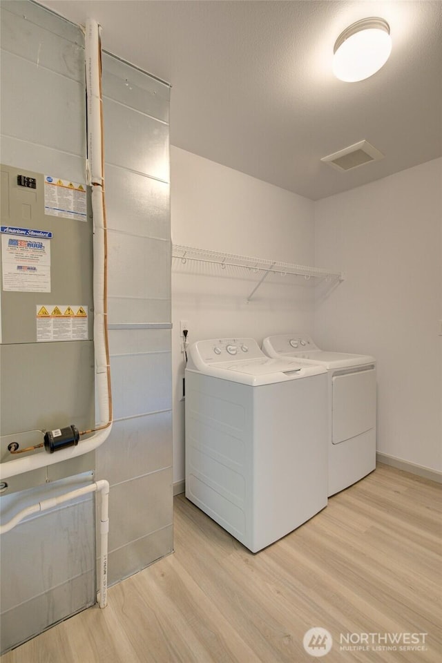 232 Jett Ct, Montesano, WA 98563 - laundry room featuring separate washer and dryer and wood finished floors