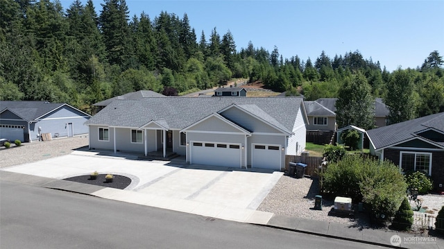 232 Jett Ct, Montesano, WA 98563 - ranch-style house with an attached garage, concrete driveway, covered porch, and a shingled roof