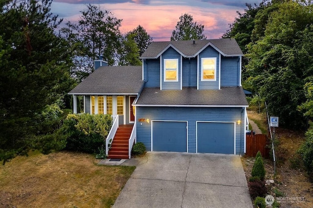 2819 SW 350th Pl, Federal Way, WA 98023 - traditional-style house with concrete driveway, a garage, stairs, roof with shingles, and a chimney