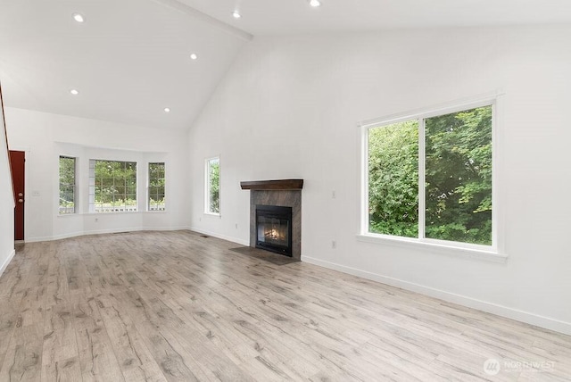2819 SW 350th Pl, Federal Way, WA 98023 - unfurnished living room with high vaulted ceiling, a tiled fireplace, light wood-type flooring, and recessed lighting
