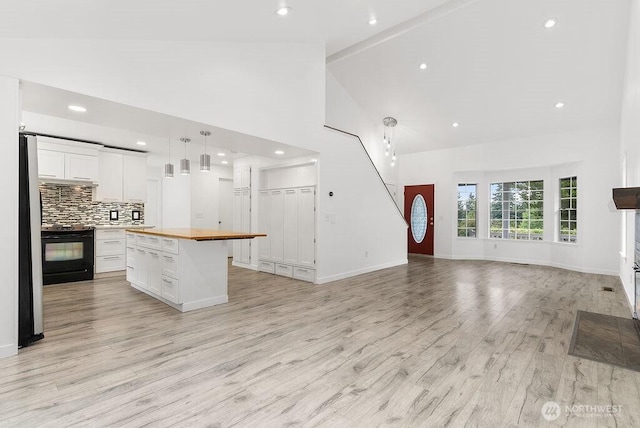 2819 SW 350th Pl, Federal Way, WA 98023 - kitchen with electric range, high vaulted ceiling, butcher block countertops, white cabinetry, and open floor plan