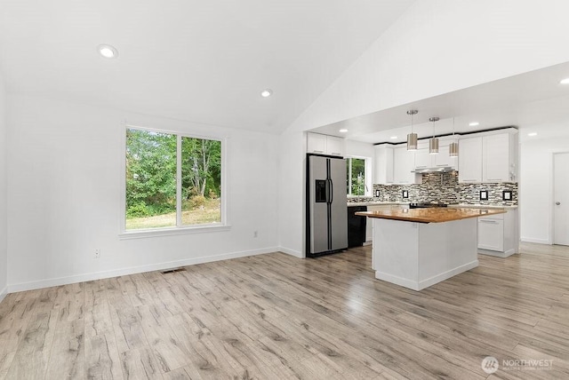 2819 SW 350th Pl, Federal Way, WA 98023 - kitchen with stainless steel fridge with ice dispenser, white cabinets, dishwasher, decorative backsplash, and a kitchen island