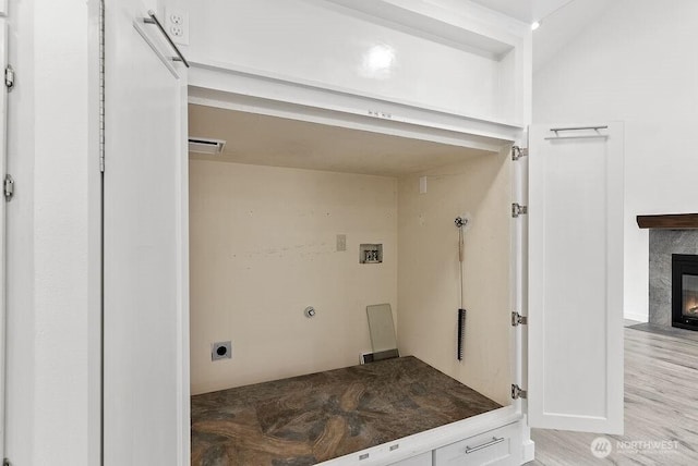 2819 SW 350th Pl, Federal Way, WA 98023 - laundry room featuring electric dryer hookup, hookup for a washing machine, a high end fireplace, and light wood finished floors