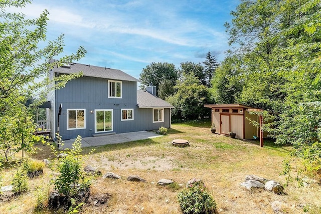2819 SW 350th Pl, Federal Way, WA 98023 - rear view of property with a storage shed, a patio, an outdoor fire pit, and a yard