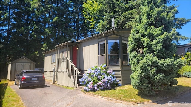 869 Mahogany Ln NW, Silverdale, WA 98383 - view of front of property with a storage shed and driveway