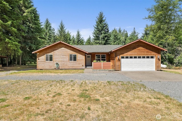 14115 Mountain Vista Dr SE, Yelm, WA 98597 - view of front of house with driveway, a front yard, and a garage
