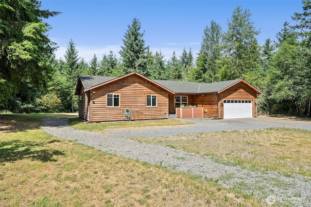 14115 Mountain Vista Dr SE, Yelm, WA 98597 - log-style house featuring driveway, an attached garage, and a front lawn