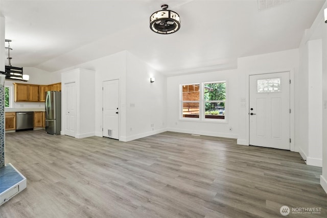 14115 Mountain Vista Dr SE, Yelm, WA 98597 - unfurnished living room with light wood-style flooring and vaulted ceiling