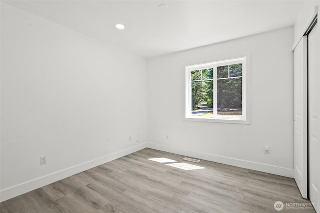 14115 Mountain Vista Dr SE, Yelm, WA 98597 - unfurnished bedroom with wood finished floors, recessed lighting, and a closet