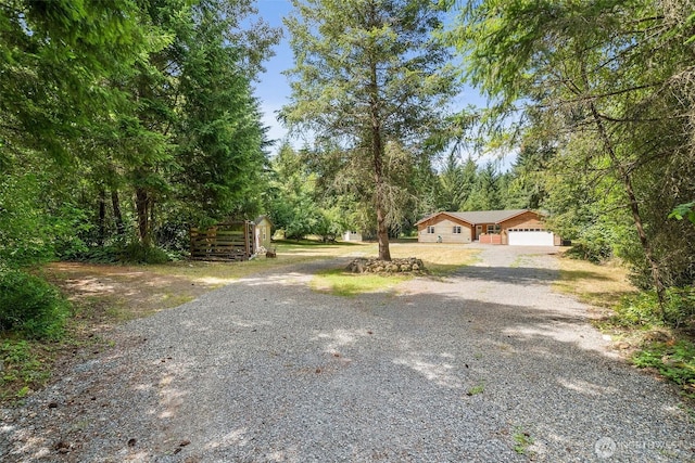 14115 Mountain Vista Dr SE, Yelm, WA 98597 - view of yard with gravel driveway and a garage