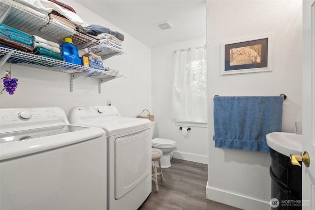 14115 Mountain Vista Dr SE, Yelm, WA 98597 - laundry room featuring dark wood-style flooring and separate washer and dryer