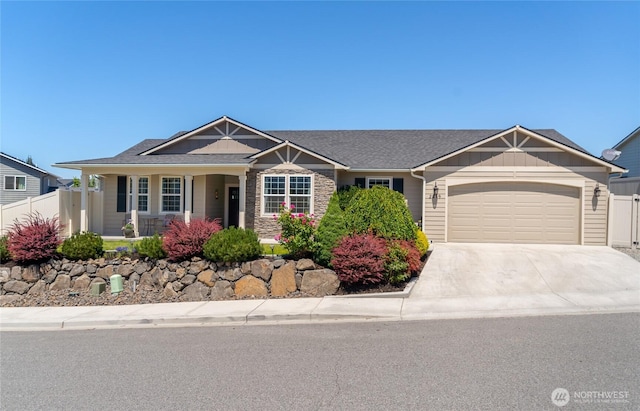 2219 Treat St SE, East Wenatchee, WA 98802 - view of front of property with an attached garage, concrete driveway, a porch, board and batten siding, and stone siding
