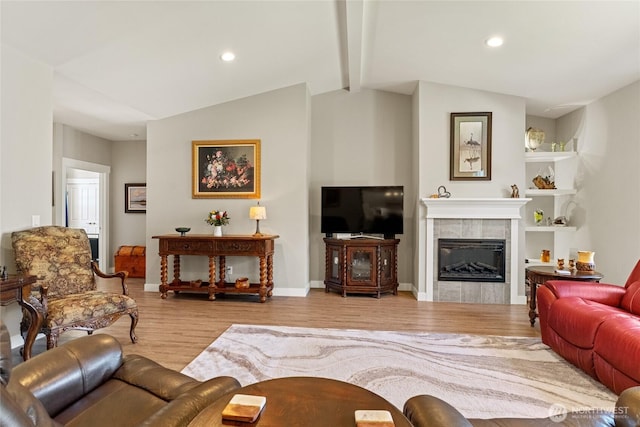 2219 Treat St SE, East Wenatchee, WA 98802 - living room featuring wood finished floors, a tiled fireplace, and recessed lighting