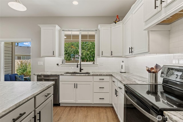 2219 Treat St SE, East Wenatchee, WA 98802 - kitchen featuring stainless steel appliances, under cabinet range hood, white cabinets, light wood finished floors, and light stone counters
