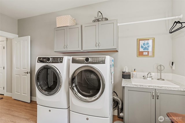 2219 Treat St SE, East Wenatchee, WA 98802 - laundry area featuring cabinet space, separate washer and dryer, and light wood-style floors