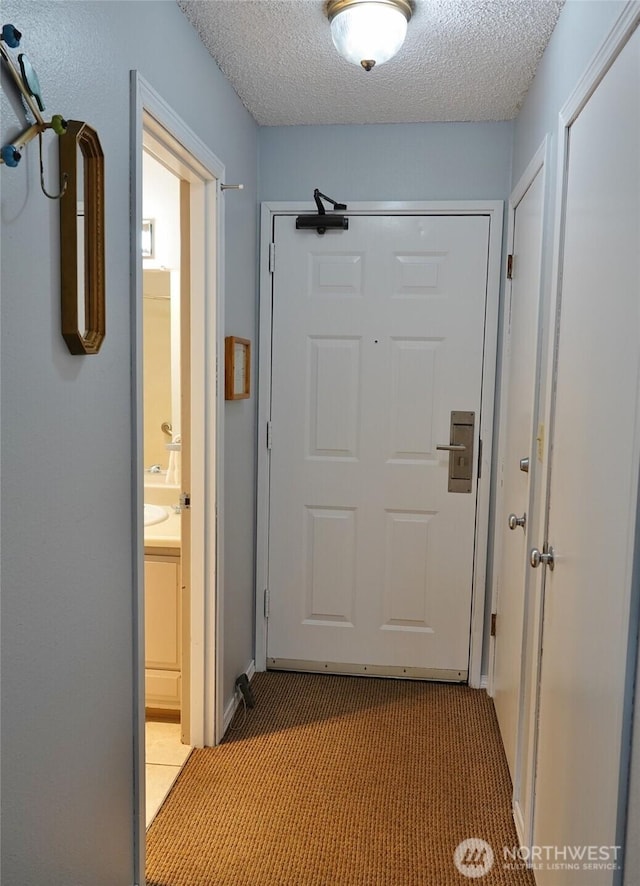 615 Ocean Shores Blvd NW Unit 115, Ocean Shores, WA 98569 - hall featuring light carpet and a textured ceiling