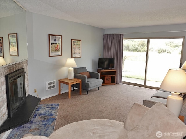 615 Ocean Shores Blvd NW Unit 115, Ocean Shores, WA 98569 - carpeted living area with a glass covered fireplace and a textured ceiling