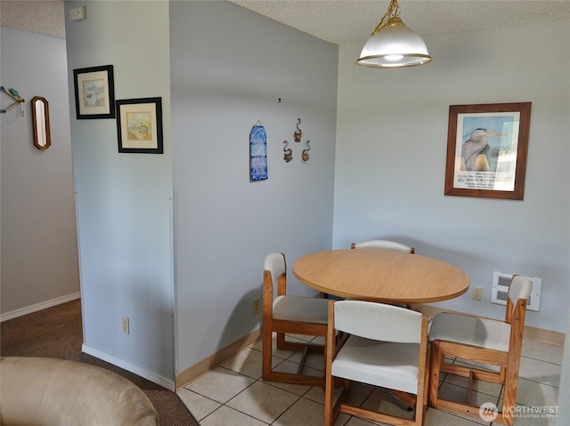 615 Ocean Shores Blvd NW Unit 115, Ocean Shores, WA 98569 - tiled dining area featuring a textured ceiling and baseboards