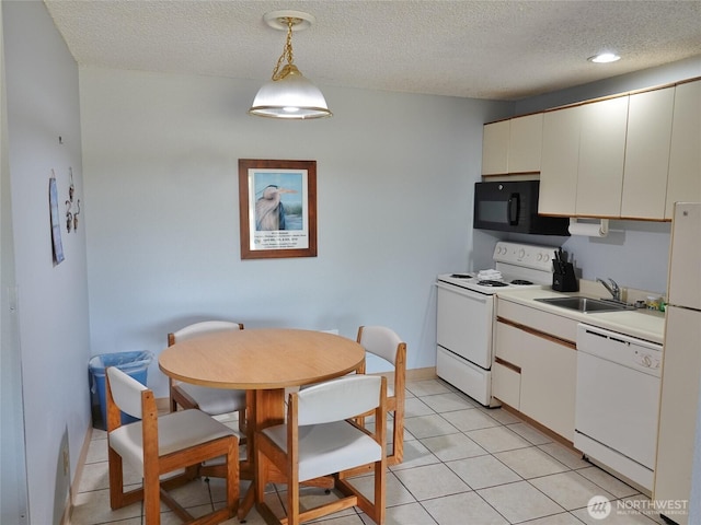 615 Ocean Shores Blvd NW Unit 115, Ocean Shores, WA 98569 - kitchen with white appliances, a textured ceiling, light countertops, hanging light fixtures, and light tile patterned flooring